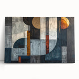 Abstract wall art featuring vibrant strokes in shades of blue, orange, and yellow on stretched canvas, leaning against a neutral wall, adding a modern touch to home decor.