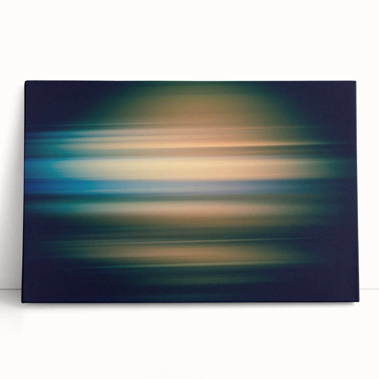 Abstract wall art featuring vibrant blue, yellow, and pink strokes on a stretched canvas, leaning against a neutral wall, adding a modern touch to home decor.