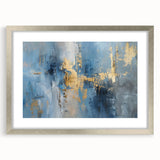Abstract wall art featuring dynamic strokes in varying shades of blue and gold, framed with a sleek silver finish, enhancing modern decor aesthetics.