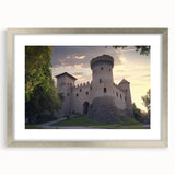 Elegant silver-framed landscape print showcasing a majestic castle surrounded by lush greenery, complete with a white mat for a polished presentation.