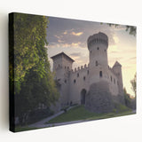 Stretched canvas artwork depicting a vibrant landscape with a majestic castle surrounded by lush greenery and rolling hills, showcasing rich colors and intricate details. Perfect for enhancing home decor with a touch of elegance and charm.