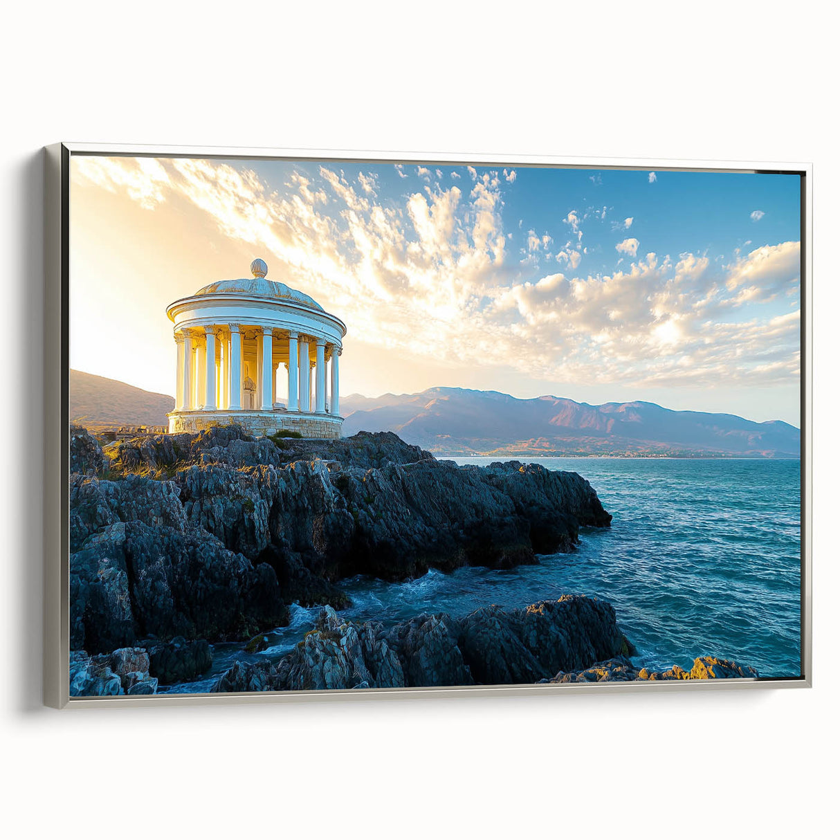 Framed canvas artwork showcasing a stunning landscape of rugged cliffs under a vibrant sky, featuring a sleek silver frame, perfect for modern home decor.