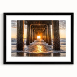 Black-framed landscape artwork showcasing serene beach scenery under a vibrant sunset, complete with a white mat for a polished look, ideal for home decor.