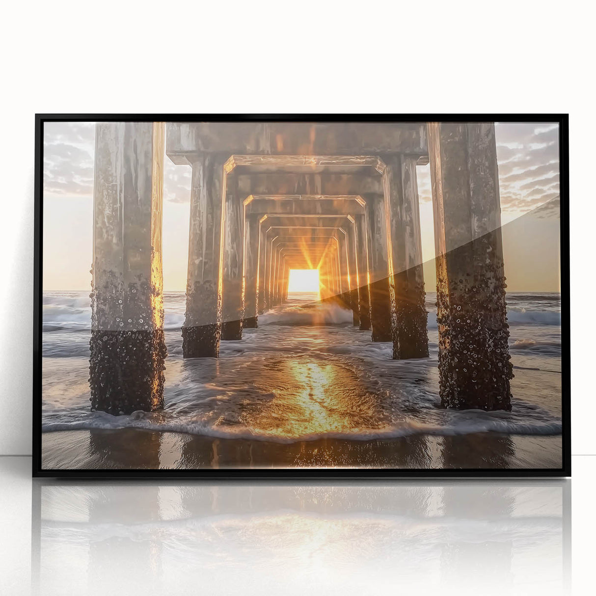 Framed acrylic artwork showcasing a serene beach landscape, featuring vibrant blues and sandy tones, set in a sleek black frame, perfect for coastal decor.