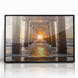 Framed acrylic artwork showcasing a serene beach landscape, featuring vibrant blues and sandy tones, set in a sleek black frame, perfect for coastal decor.