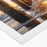 Vibrant rolled canvas artwork depicting a serene beach landscape, showcasing vivid blues and sandy hues, packaged securely in a protective cardboard tube.