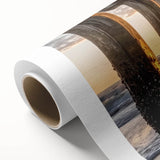 Vibrant rolled canvas artwork showcasing a serene beach landscape at sunset, featuring soft waves and colorful skies, ideal for home decor.