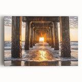 Stretched canvas artwork depicting a serene beach landscape at sunset, featuring vibrant orange and blue hues, ideal for coastal home decor. Perfect for creating a calming atmosphere in living spaces.