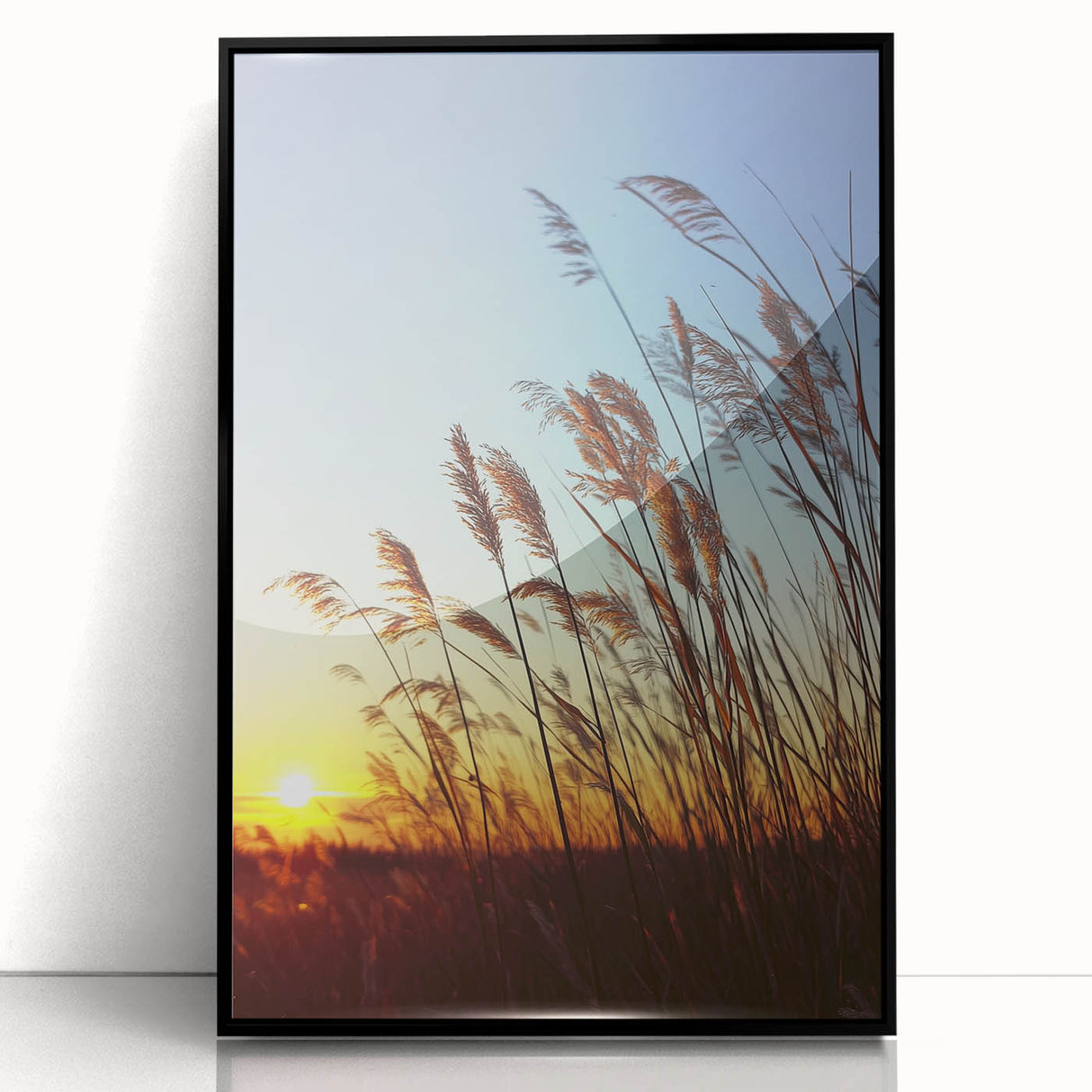 Framed acrylic artwork depicting a serene countryside landscape, featuring vibrant green fields and a clear blue sky, set in a sleek black frame for modern decor.