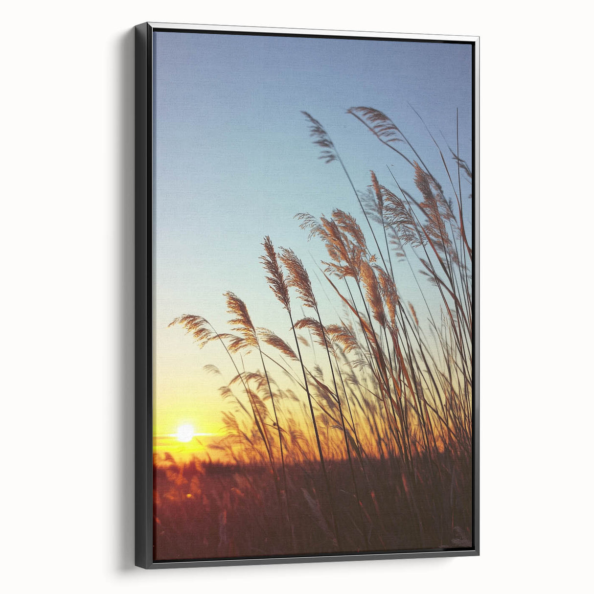 Framed canvas artwork depicting a serene countryside landscape, featuring rolling green hills and a vibrant blue sky, showcased from a black side view. Ideal for home decor.