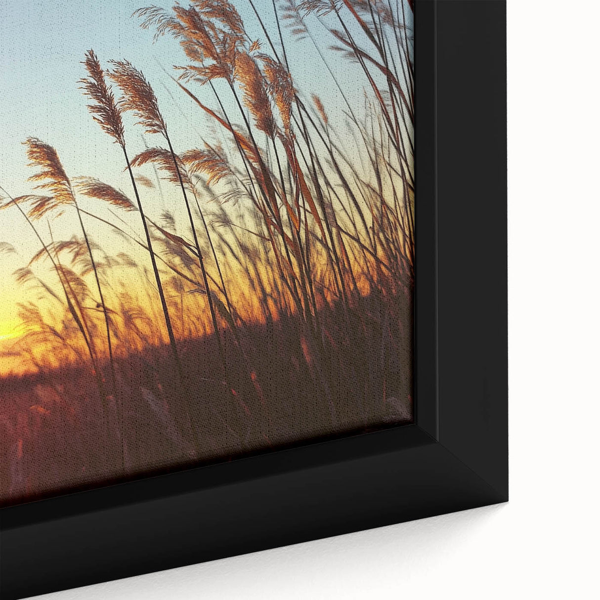 Close-up of a framed canvas artwork depicting a serene countryside landscape, showcasing vibrant green fields and a clear blue sky, ideal for home decor.