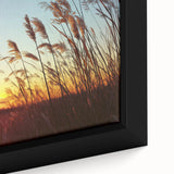 Close-up of a framed canvas artwork depicting a serene countryside landscape, showcasing vibrant green fields and a clear blue sky, ideal for home decor.