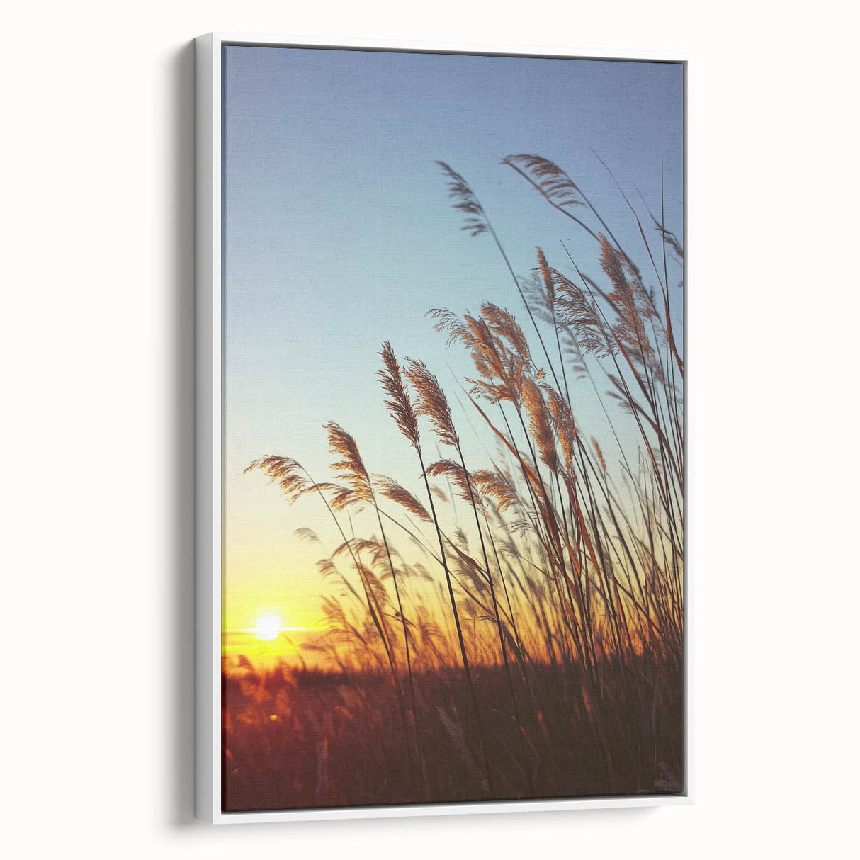 Framed canvas artwork depicting a serene countryside landscape with vibrant green fields and a clear blue sky, showcased from a white side view for elegant home decor.