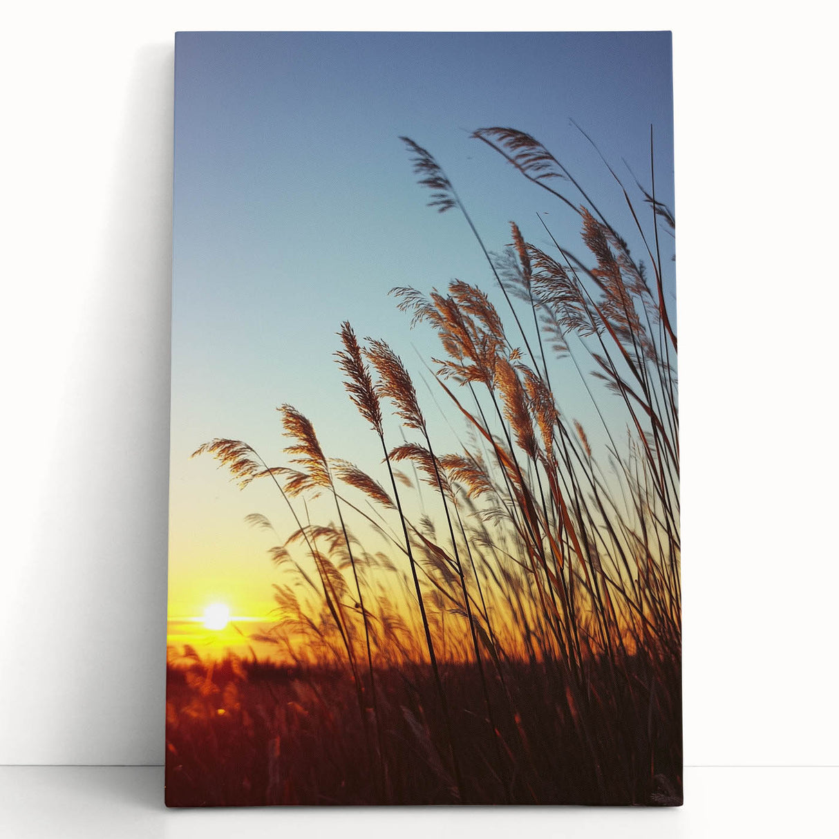 Stretched canvas artwork depicting a serene countryside landscape with rolling hills and vibrant greenery, leaning against a rustic wall, perfect for home decor.