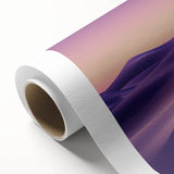 Rolled canvas showcasing a vibrant desert landscape, featuring warm hues of orange and yellow, elegantly packaged in a protective cardboard tube for safe shipping.