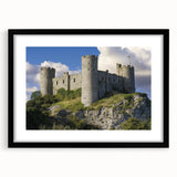Black-framed landscape artwork showcasing a majestic castle surrounded by lush greenery, elegantly matted for a sophisticated presentation, perfect for home decor.