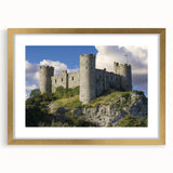 Elegant gold-framed landscape artwork depicting a majestic castle surrounded by lush greenery, showcasing intricate detailing and a sophisticated mat finish, ideal for home decor.