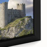 Close-up of a framed canvas artwork showcasing a stunning landscape with a medieval castle set against a vibrant sunset, featuring rich colors and intricate details. This decorative piece adds an elegant touch to any home or office decor.