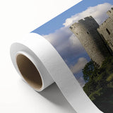Rolled canvas artwork showcasing a stunning landscape of a medieval castle surrounded by lush greenery and a clear blue sky, ideal for home decor.