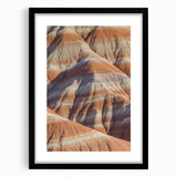 Framed black landscape artwork showcasing dramatic cliffs, featuring a white mat for added elegance. Ideal for modern home decor and art enthusiasts.