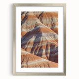 Framed landscape artwork depicting dramatic cliffs in a natural setting, featuring a sleek silver mat and frame, ideal for enhancing modern home decor aesthetics.