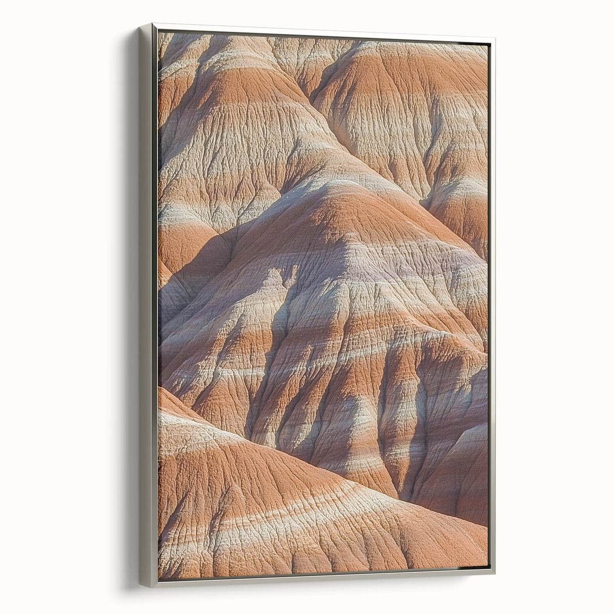 Framed canvas depicting a stunning landscape of rugged cliffs under a blue sky, showcasing silver accents. Ideal for modern home decor or office settings.