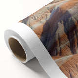 Vibrant rolled canvas showcasing a stunning landscape of dramatic cliffs under a bright blue sky, designed for home decor elegance and artistic appeal.