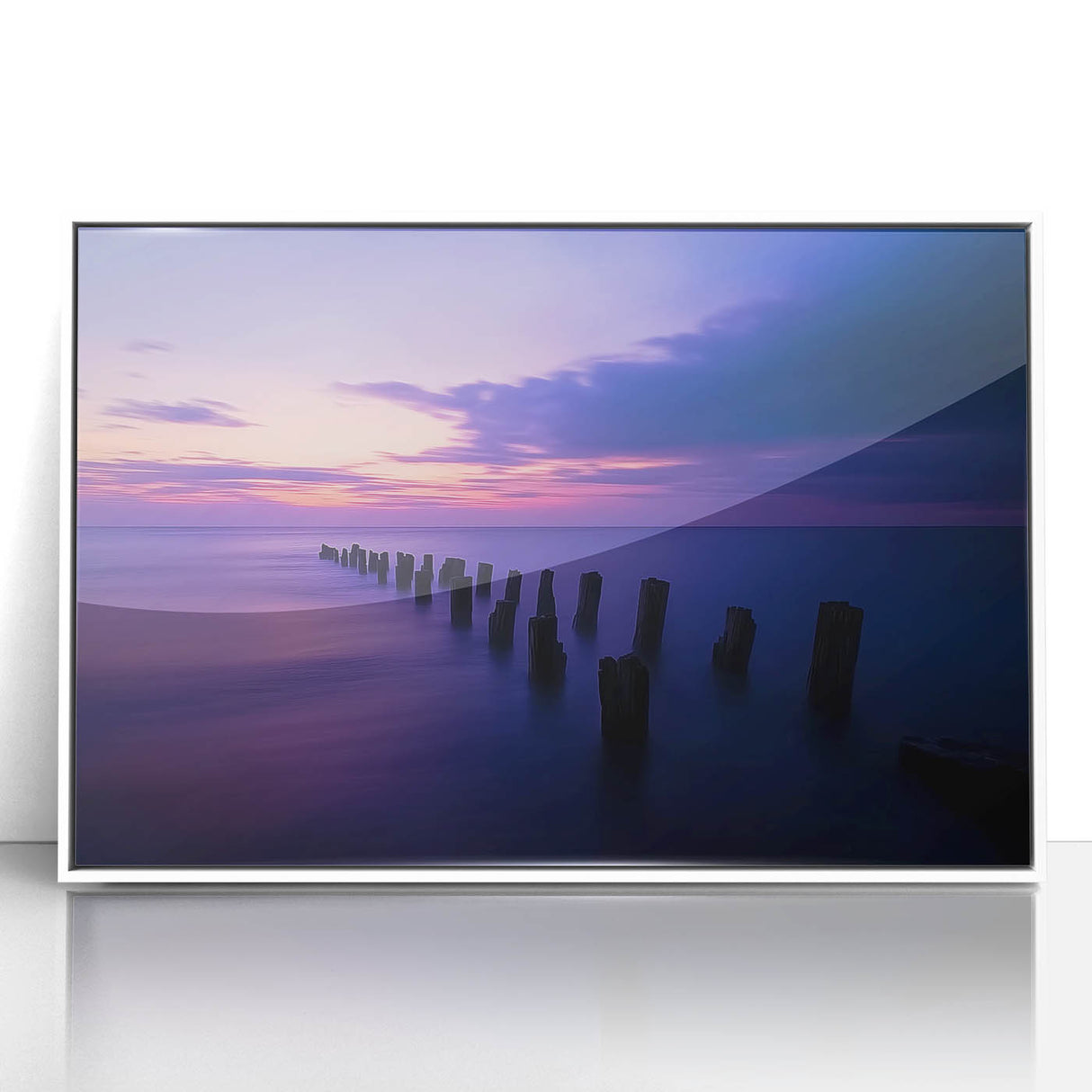 Framed acrylic artwork depicting a serene beach landscape with vibrant colors, featuring clear blue skies, soft white sand, and gentle waves, perfect for coastal decor.