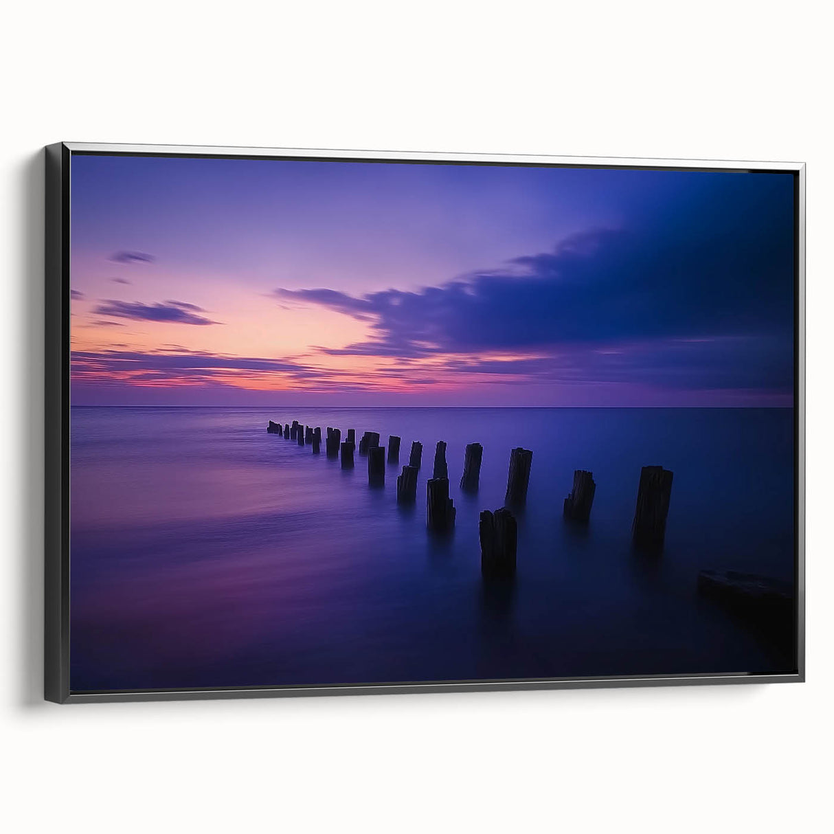 Framed canvas artwork showcasing a picturesque beach landscape with vibrant colors, featuring a black frame and side view for a modern aesthetic. Ideal for coastal decor enthusiasts.