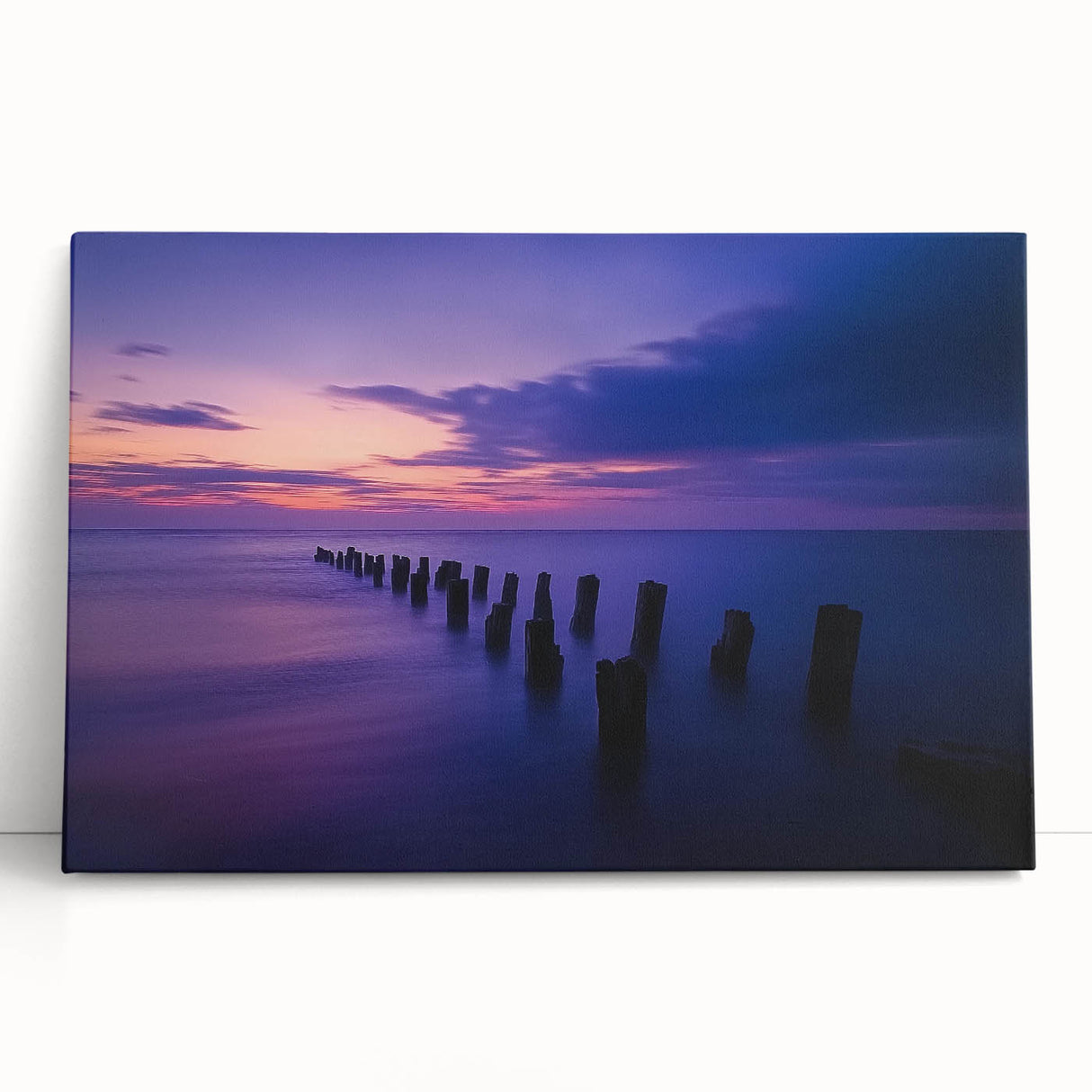 Stretched canvas artwork showcasing a serene beach landscape with vibrant blue waters and golden sand, perfect for enhancing home decor or coastal-themed spaces.