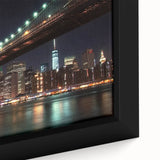 Close-up of a framed canvas depicting a serene landscape with a bridge over a tranquil river, showcasing vibrant greens and blues, perfect for home decor.