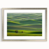 Silver-framed landscape art print showcasing a serene countryside scene, featuring vibrant colors and a white mat, ideal for home decor or gallery display.
