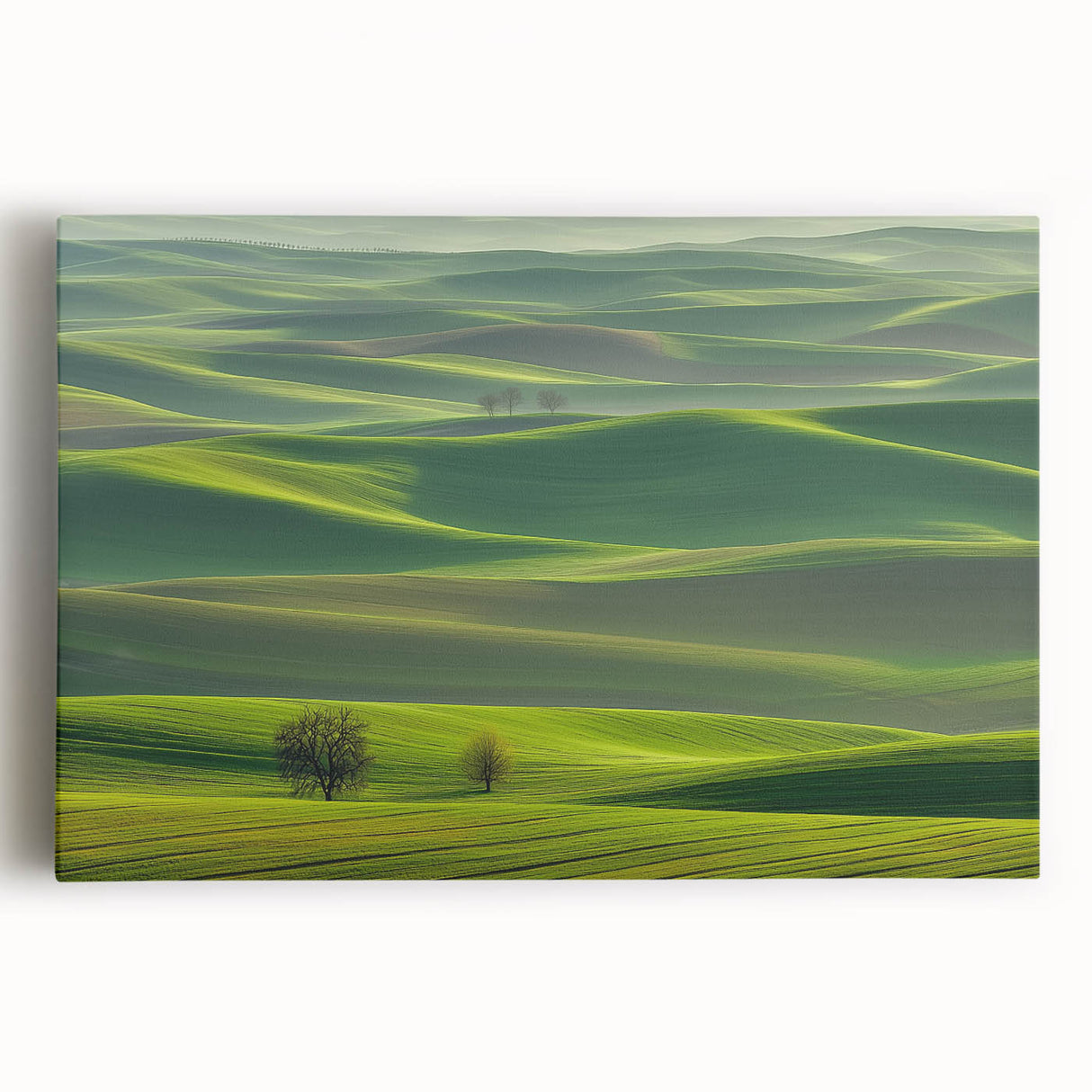 Stretched canvas artwork depicting a serene countryside landscape with vibrant green fields, a blue sky, and distant hills, perfect for home decor.