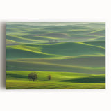 Stretched canvas artwork depicting a serene countryside landscape with vibrant green fields, a blue sky, and distant hills, perfect for home decor.