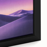 Close-up of a framed desert landscape canvas art piece showcasing vibrant hues of orange and yellow sunset over rugged terrain, perfect for home decor.