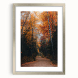 Textured art of abstract autumn leaves in earth tones, framed in silver, suitable for bedroom decor.