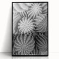 Framed wall art featuring a botanical design of cacti in vibrant green and earthy tones, displayed in a sleek black frame, perfect for modern decor.