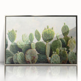 Framed wall art featuring a botanical cactus design with vibrant green hues, set in a sleek silver frame, perfect for modern home decor or office spaces.