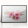 Framed acrylic wall art showcasing a delicate cherry blossom design with intricate pink flowers and green leaves set against a black background, adding elegance to any interior decor.
