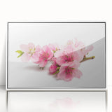 Framed acrylic wall art featuring a delicate cherry blossom design in soft pinks and whites, set against a sleek white background, perfect for enhancing modern home decor.