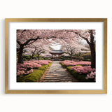 Elegant botanical wall art depicting cherry blossoms in a gold frame with matting, showcasing delicate pink flowers against a soft background, perfect for home decor.
