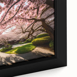 Close-up of a framed botanical wall art piece showcasing delicate pink cherry blossoms on a soft white background, perfect for home decor and spring aesthetics.