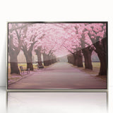 Framed wall art featuring a botanical cherry blossom design in soft pink and white tones, set against a sleek silver frame for an elegant touch to home decor.