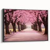 Framed canvas wall art showcasing a botanical cherry blossom design, featuring soft pink flowers and green leaves, displayed elegantly from a black side view. Ideal for enhancing home decor with a touch of nature.