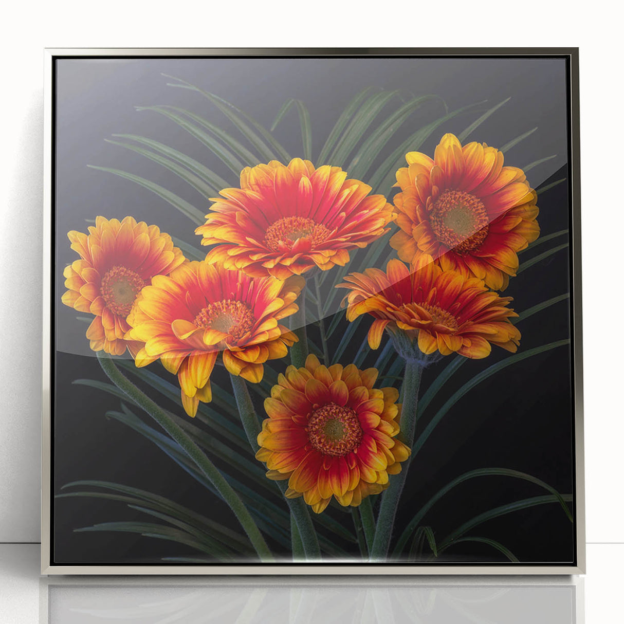 Framed wall art showcasing a botanical daisy design in vibrant colors, with a sleek silver frame, perfect for enhancing modern home decor aesthetics.