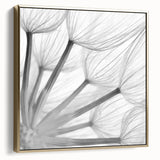 Framed botanical wall art featuring a delicate dandelion design on a silver and gold canvas, ideal for home decor with a modern, elegant touch. Perfect for nature enthusiasts.