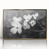 Framed wall art featuring a botanical dogwood design in vibrant colors, set in a sleek gold frame, perfect for home decor and enhancing interior aesthetics.
