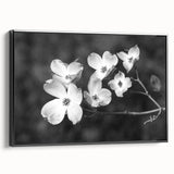 Framed botanical wall art featuring a delicate dogwood flower design, showcased in a sleek black frame with a side view to highlight its elegant details.