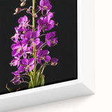 Close-up of a framed botanical wall art piece featuring vibrant fireweed flowers in shades of pink and green, set against a textured background for added depth.