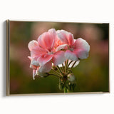 Framed botanical wall art featuring a vibrant geranium design on canvas, accented with a gold frame, showcasing intricate floral details in a stylish side view.